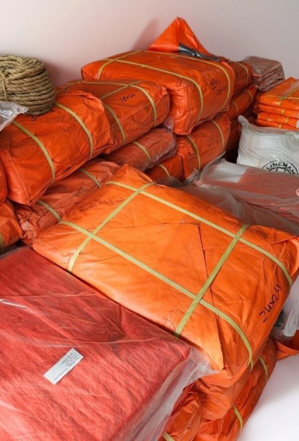 Orange Bundle of PVC Tarpaulin Sheets Available in Abu Dhabi Store